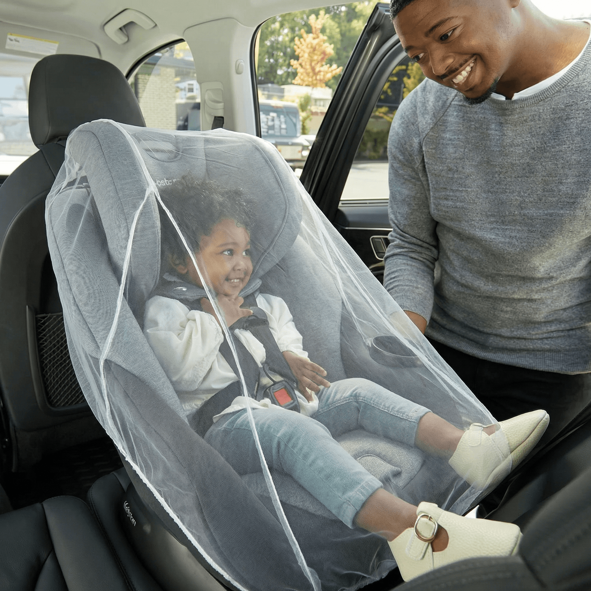 Mosticare Bambino Carello WHO-prequalified stroller mosquito net draped over a European pram on a park bench.